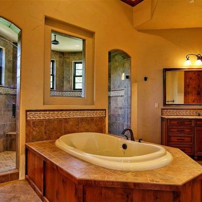 A bathroom with a bathtub and a mirror