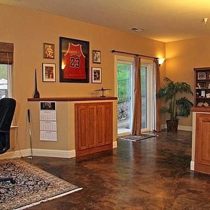 A living room with a michael jordan jersey on the wall
