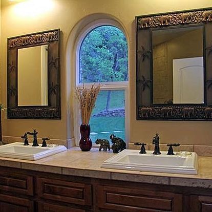 A bathroom with two sinks and two mirrors