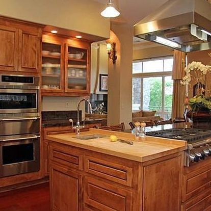 A kitchen with wooden cabinets and stainless steel appliances