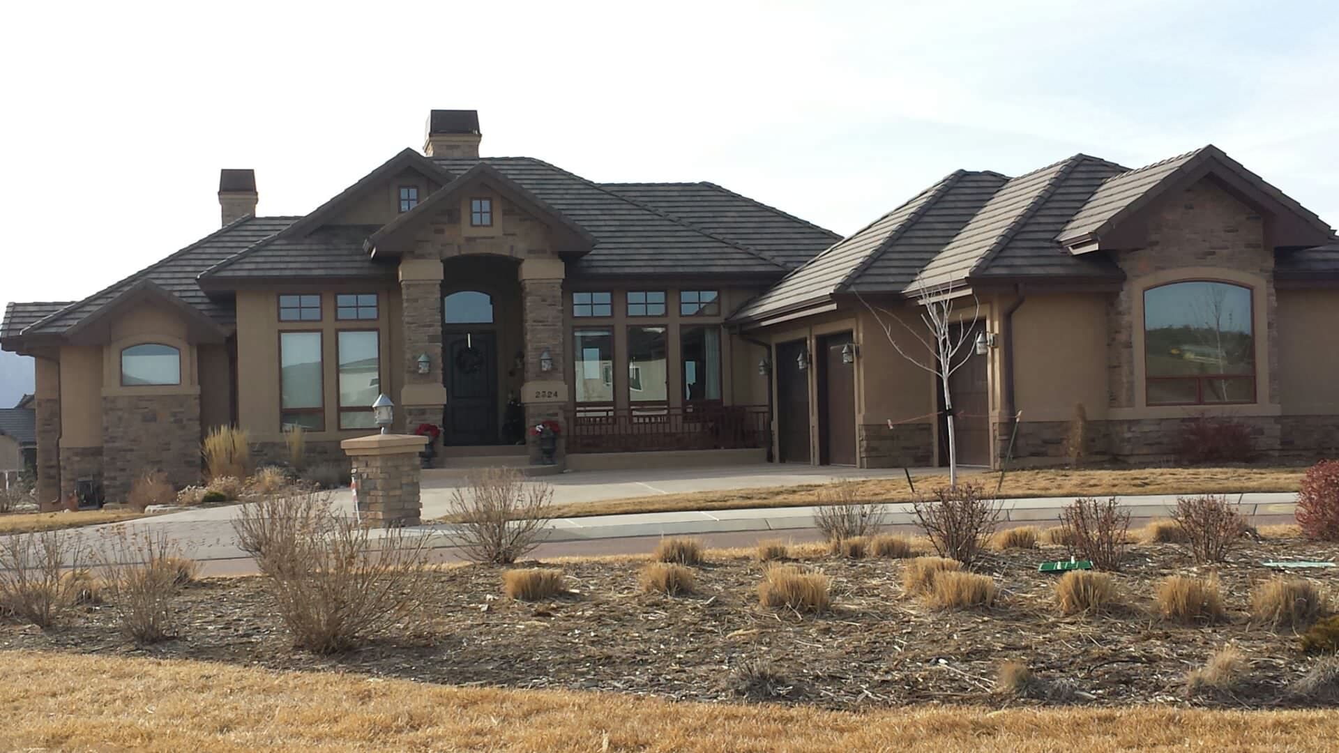 A large house with a lot of windows and a roof