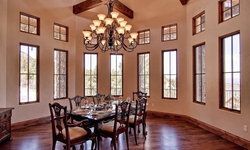 A dining room with a table and chairs and a chandelier.