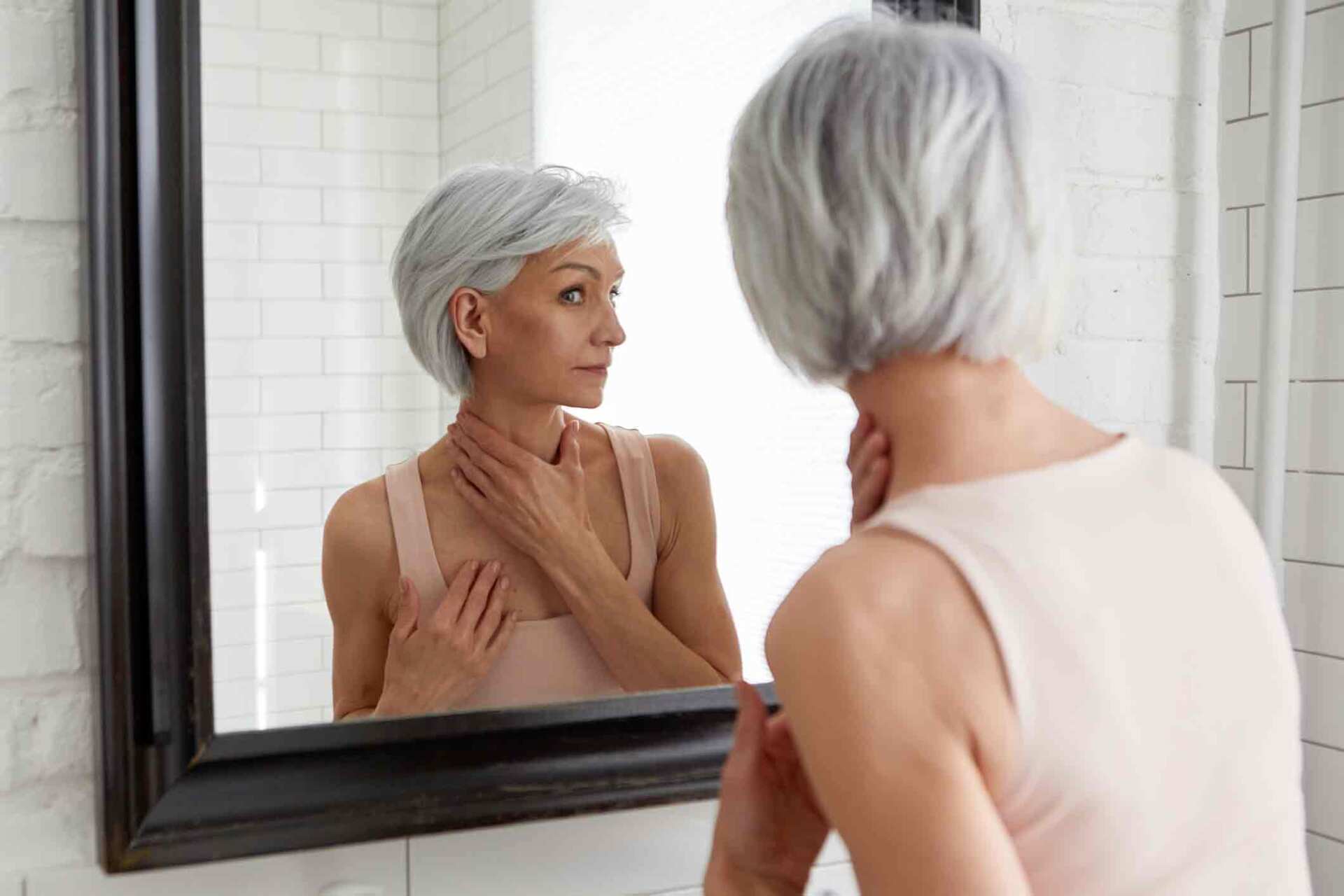 Woman Looking At Herself In Mirror — Plano, TX — North Texas Medical Anti-Aging Center