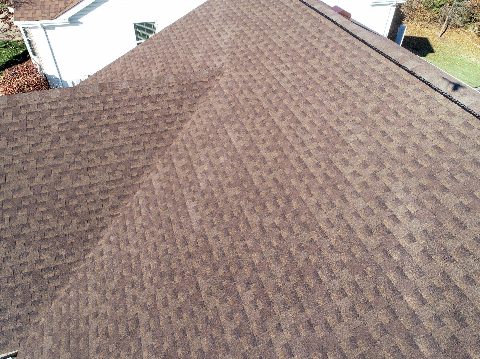 an aerial view of a brown roof of a house