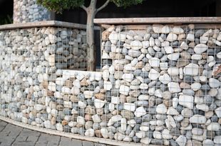 a fence made of rocks and wire .