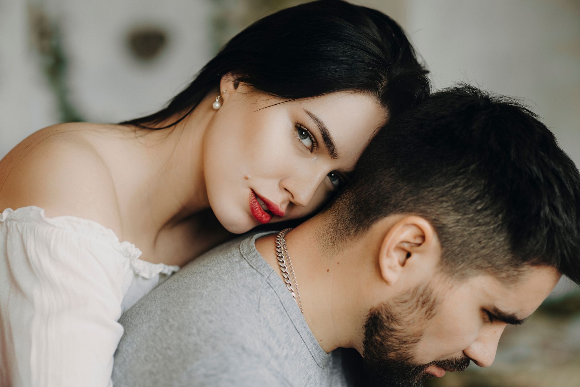 A woman is putting her head on a man 's shoulder.