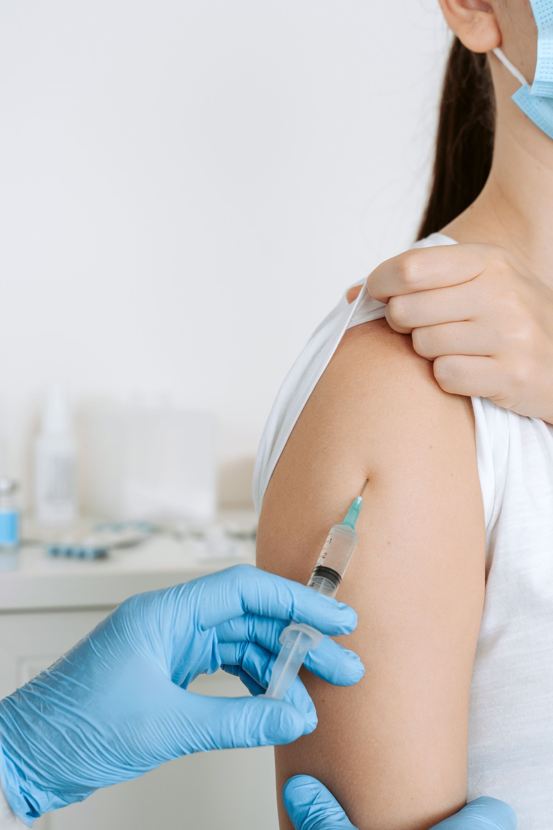 A woman is getting an injection in her arm.