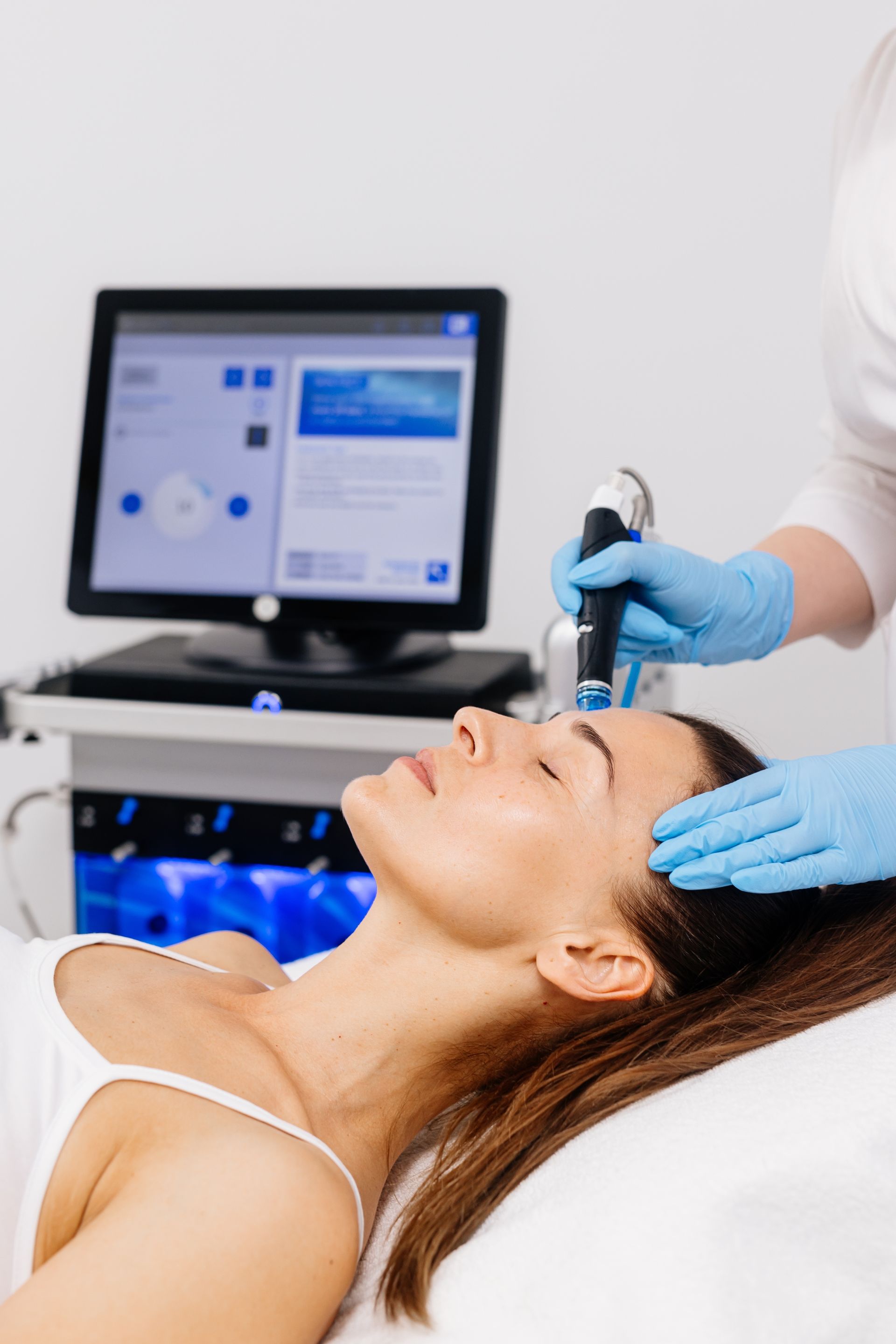 A woman is getting a facial treatment in a beauty salon.