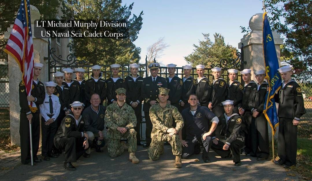 A group of men in military uniforms pose for a picture