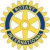 A yellow and blue rotary international logo on a white background.