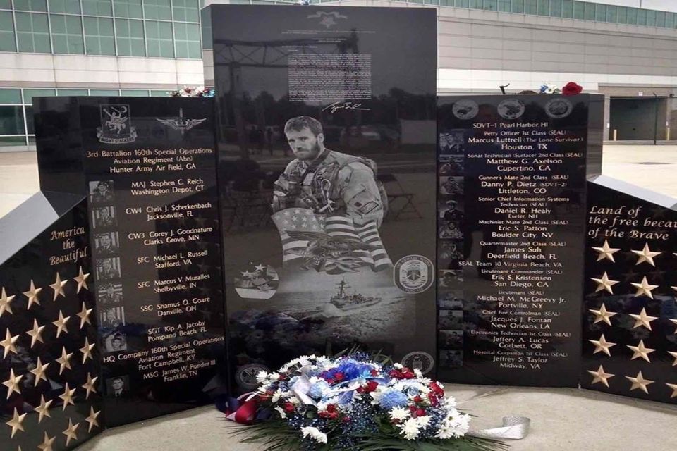 A memorial with a wreath in front of it