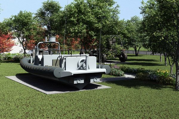 A boat is parked in a grassy area with trees in the background