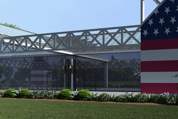 A large american flag is in front of a building