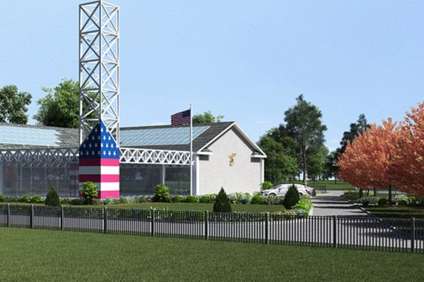 A large american flag is in front of a building