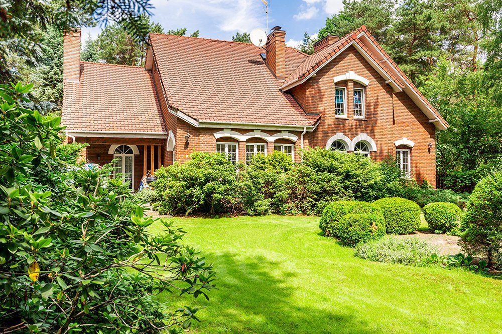 House with Bushes and Green Lawn | Charlottesville, VA | Hebron  Valley Title