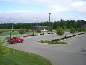 Red Car on Asphalt Parking Lot — Seal Coating in Fort Wayne, IN