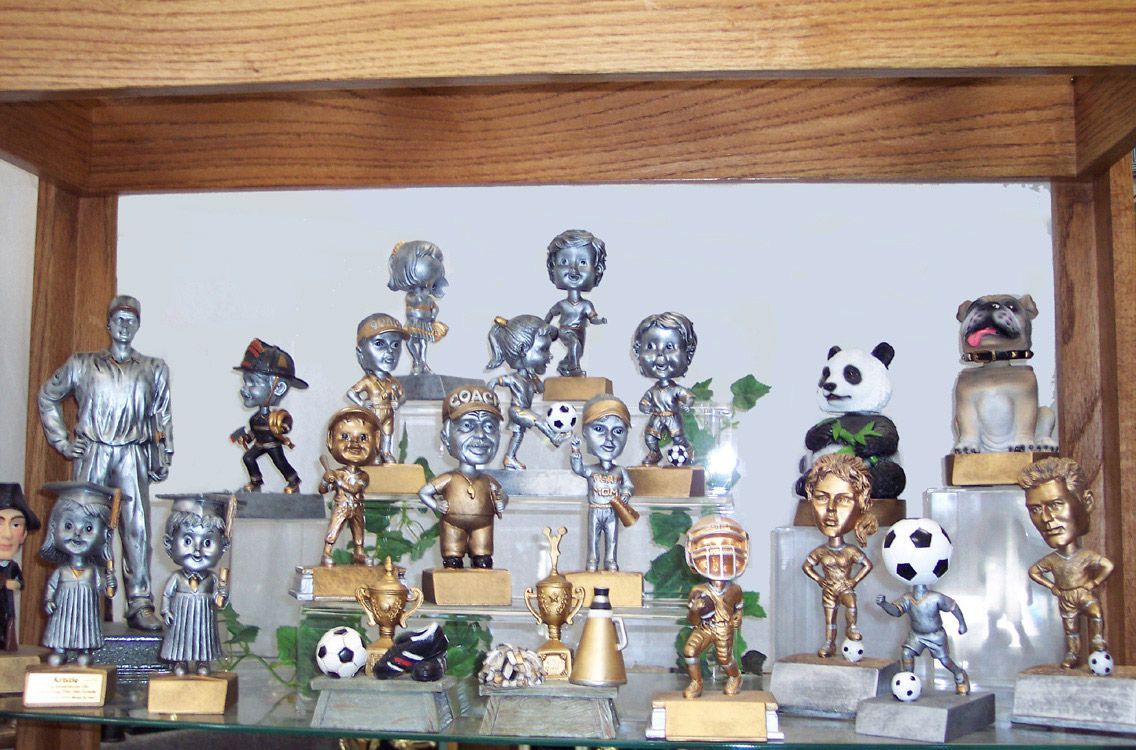 A group of trophies are sitting on a wooden table— Riverside, CA  — Awesome Awards Western Trophy