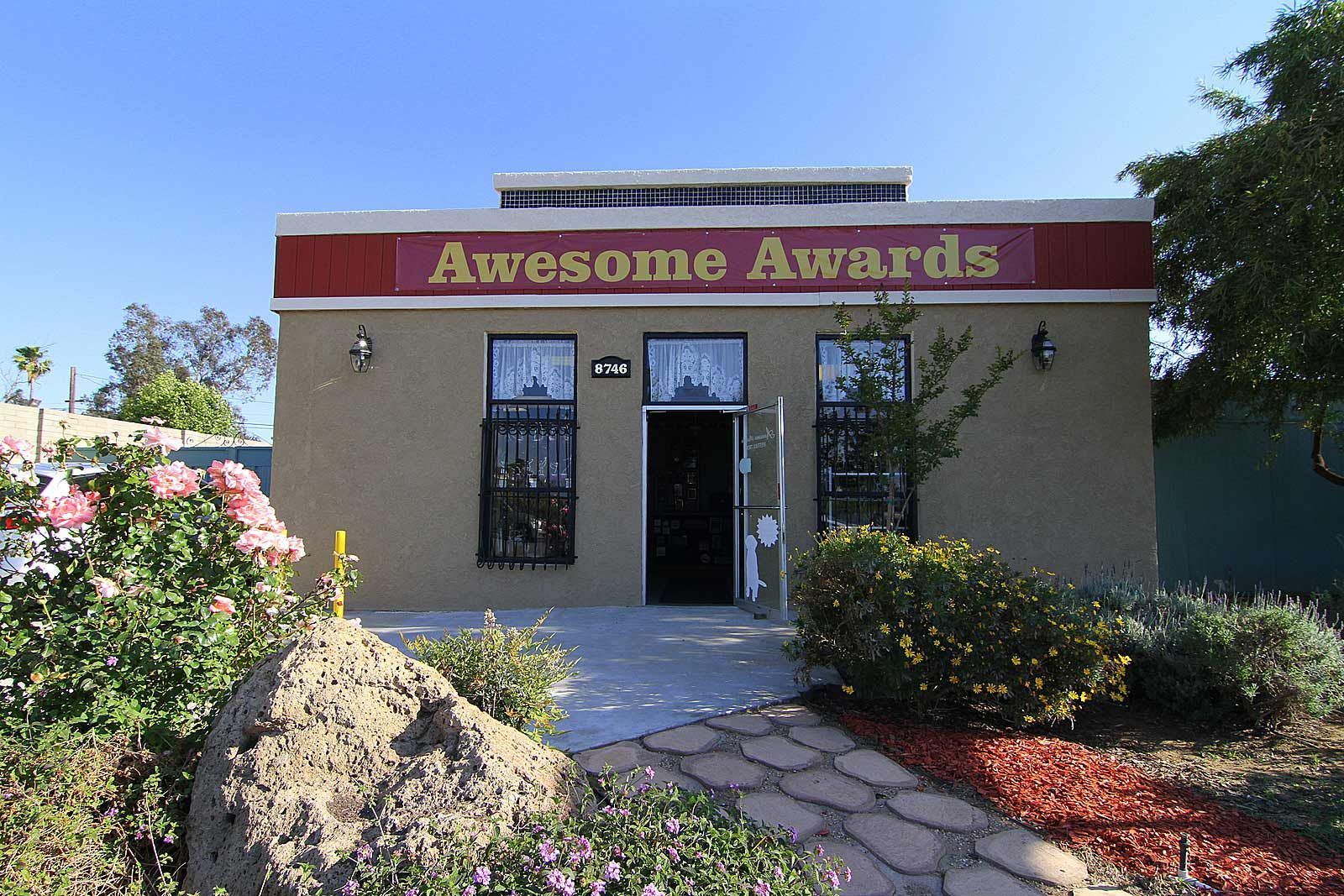 A row of gold and silver trophies on a shelf — Riverside, CA  — Awesome Awards Western Trophy