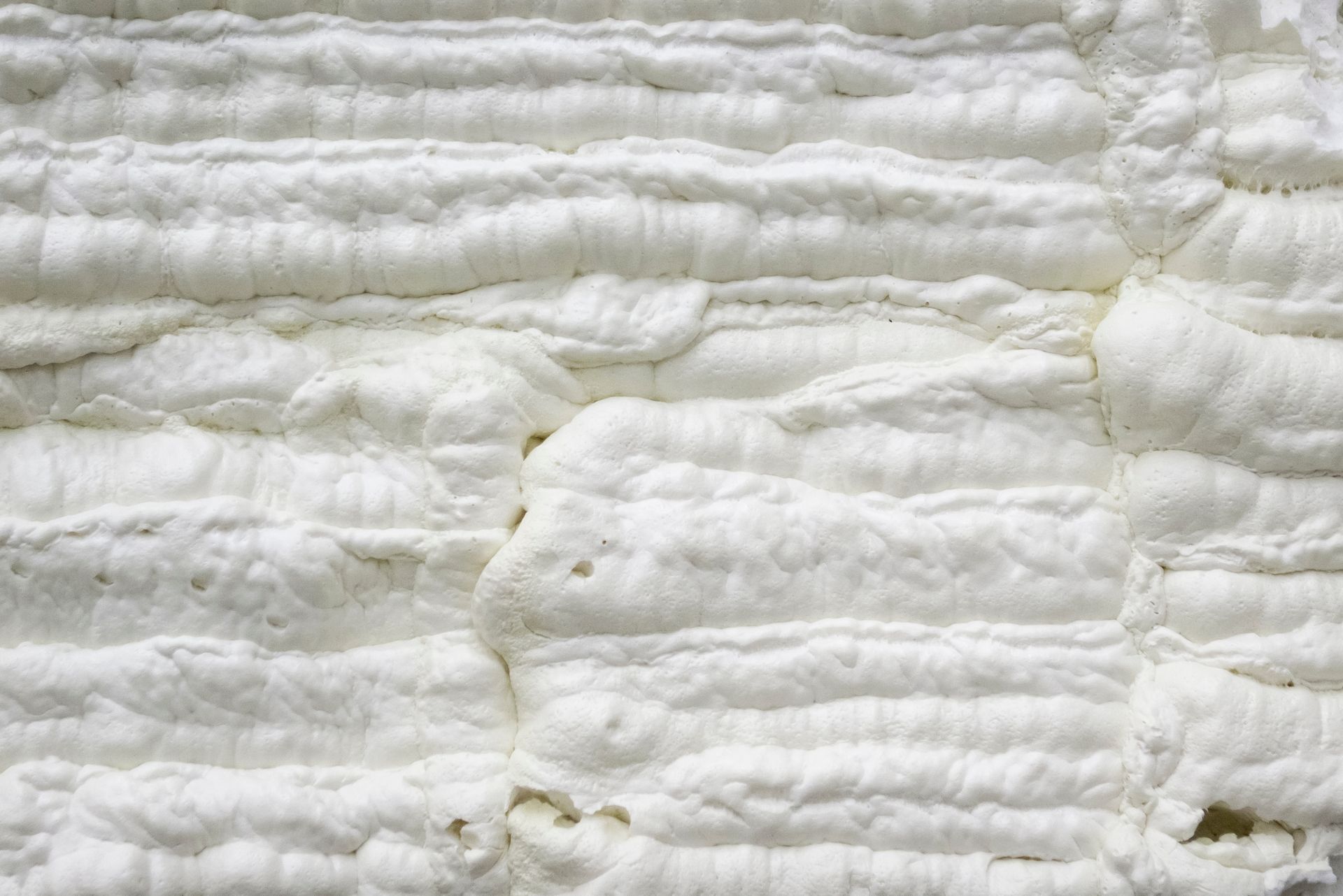 A close-up of a piece of white foam on a wall.