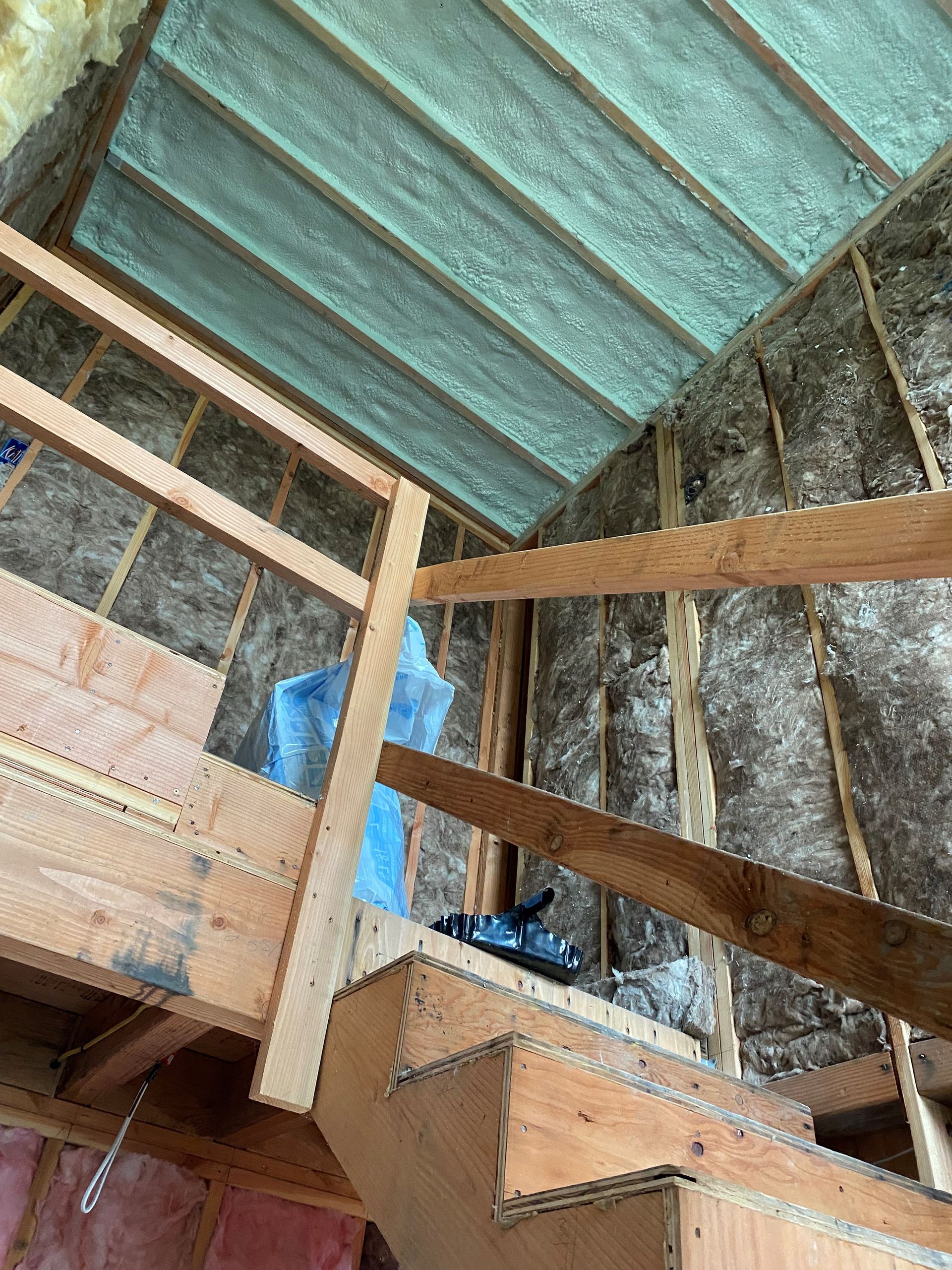 A staircase leading up to a loft in a house under construction.