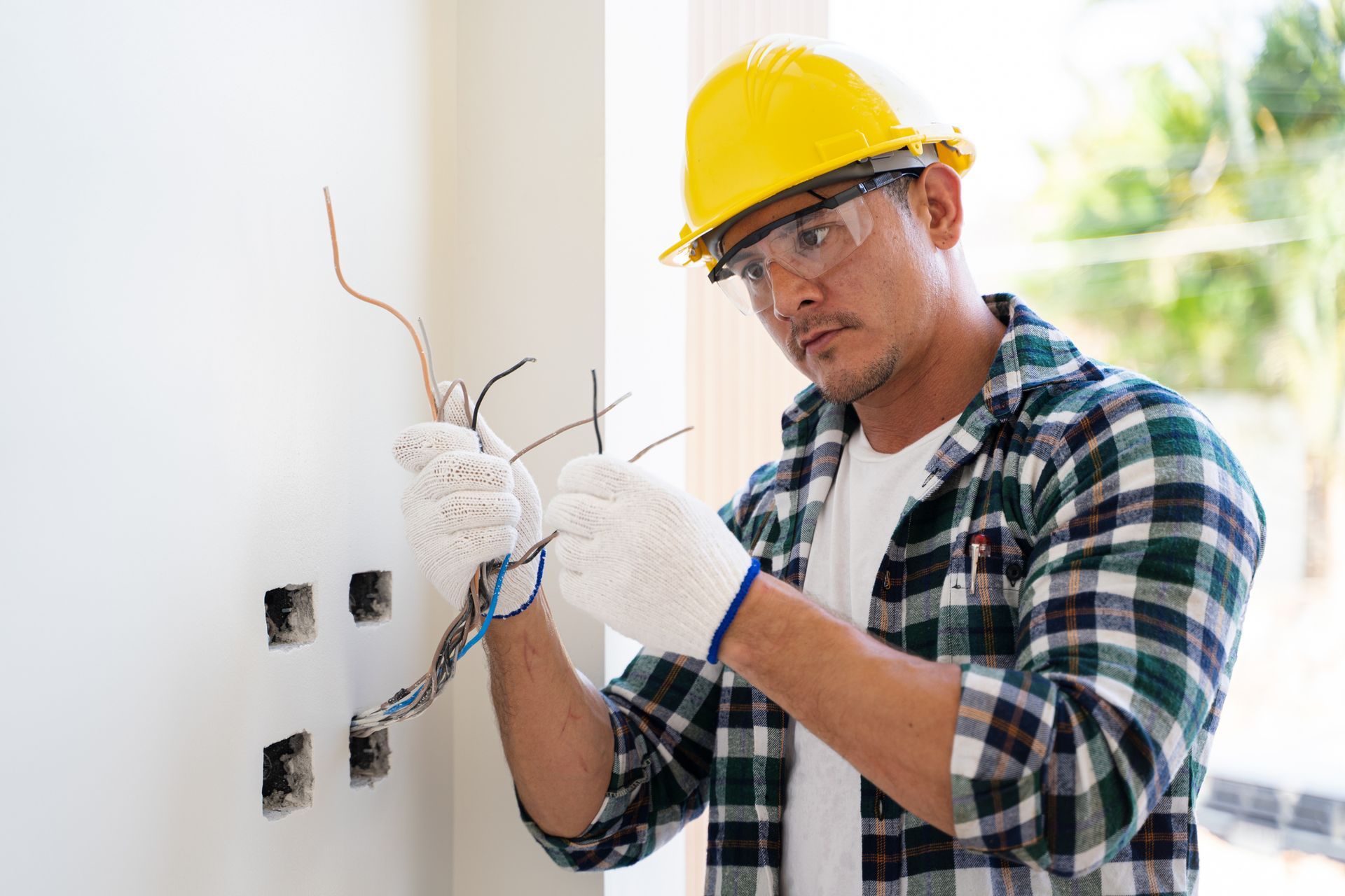 Certified electrician setting up wiring in residential construction. Certified electrician setting up wiring in residential construction.