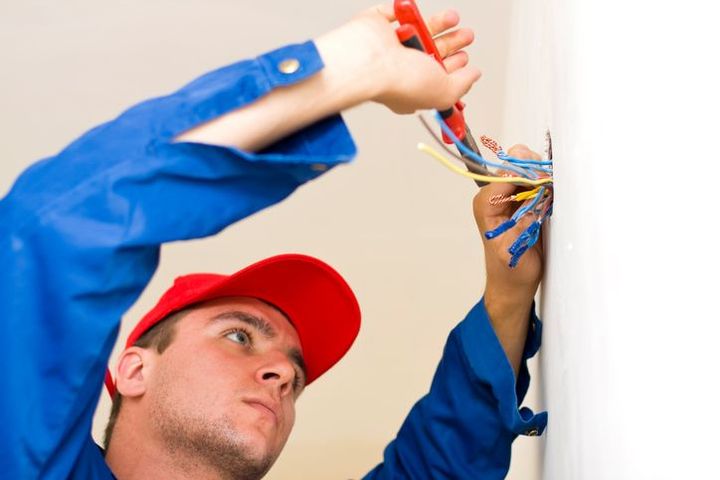 An expert technician performs electrical repair services by cutting cables for safe installations.