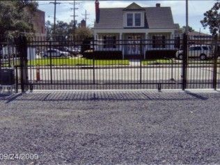 Black metal gate in front of a house