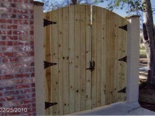 Wooden double gate with arched top