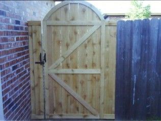 Wooden gate with arched top