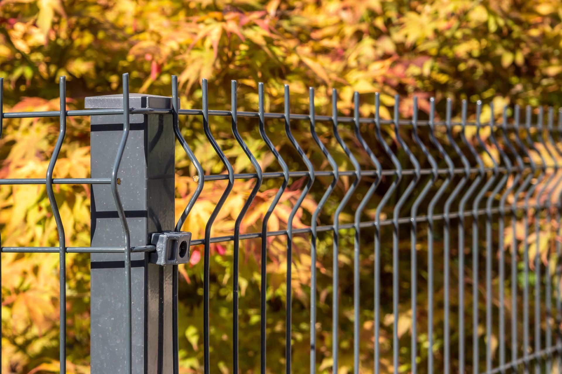 Dark gray metal fence with wavy wires
