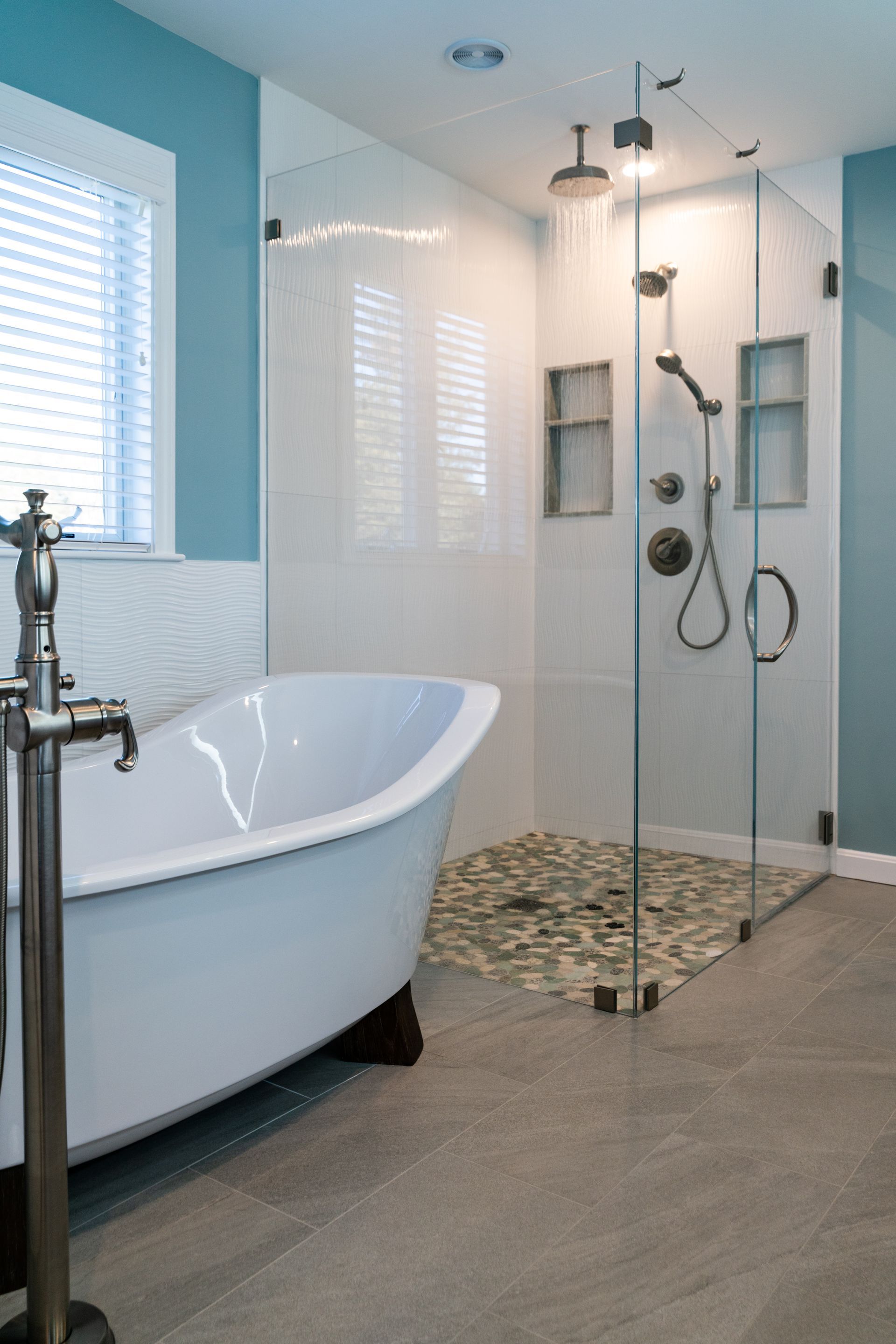 Modern bathroom with a freestanding tub, glass shower, and tiled walk-in shower area.