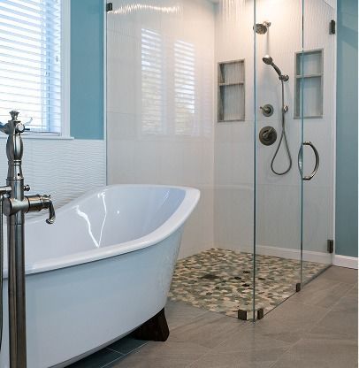 Modern bathroom with freestanding tub, glass shower, and mosaic tile floor