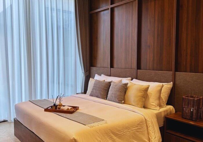 There is a tray on the bed in the bedroom.