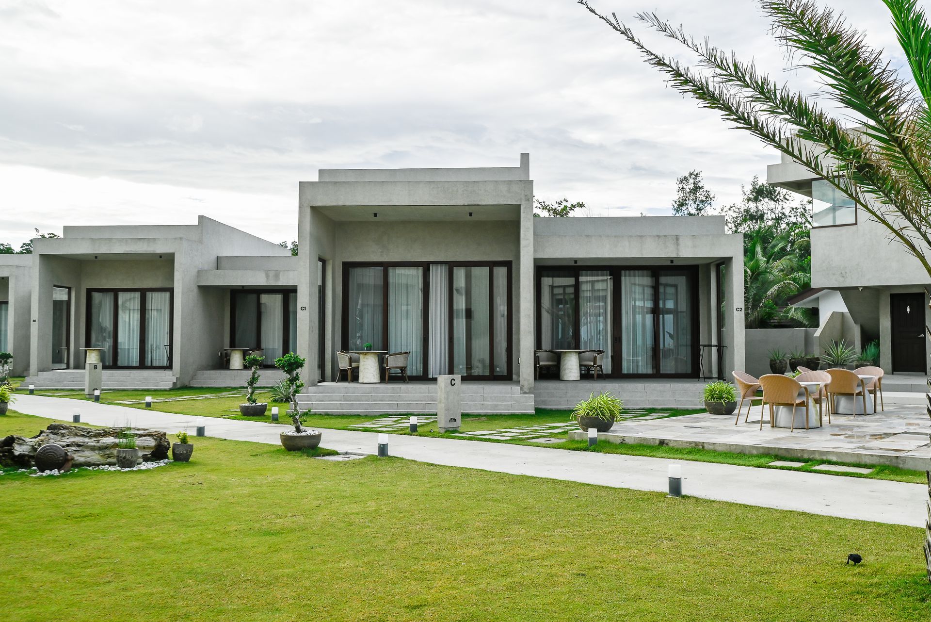 A row of houses are sitting next to each other on a lush green lawn.