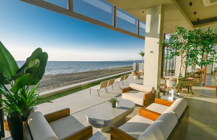 A living room with a view of the ocean.