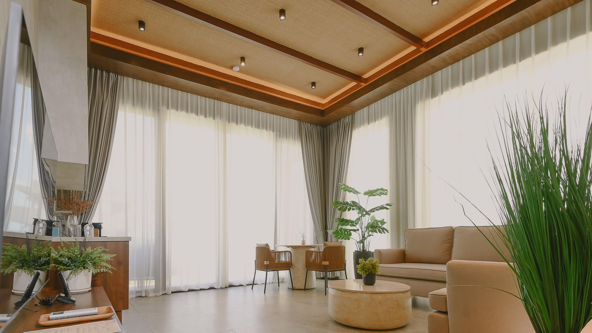 A living room with a couch , chairs , table and television.