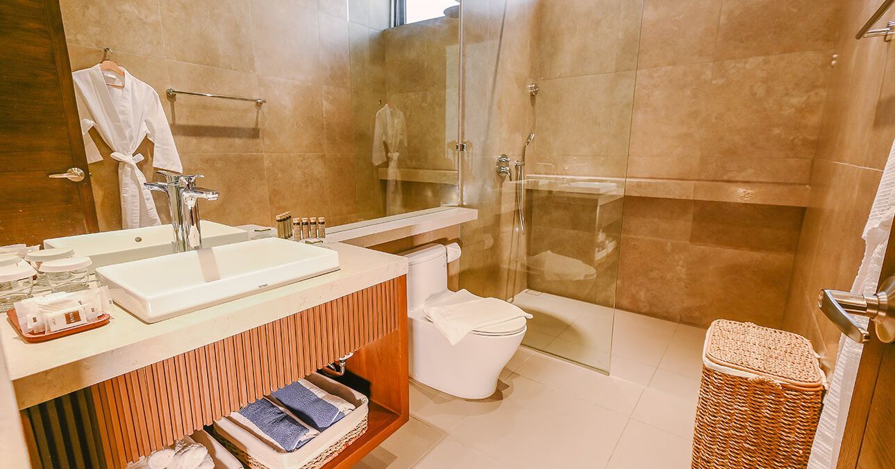 A bathroom with a sink , toilet , and walk in shower.