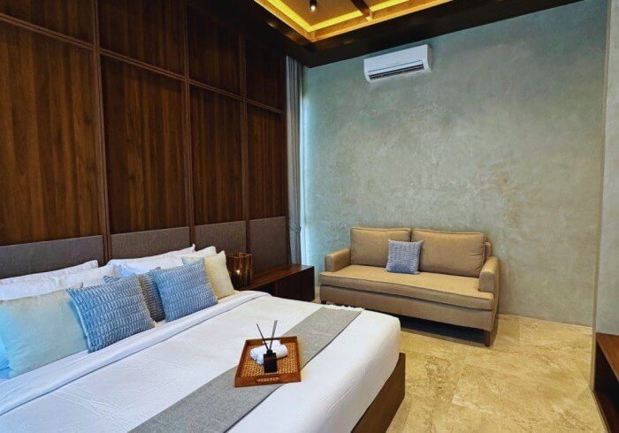 A bedroom with a king size bed and a couch.