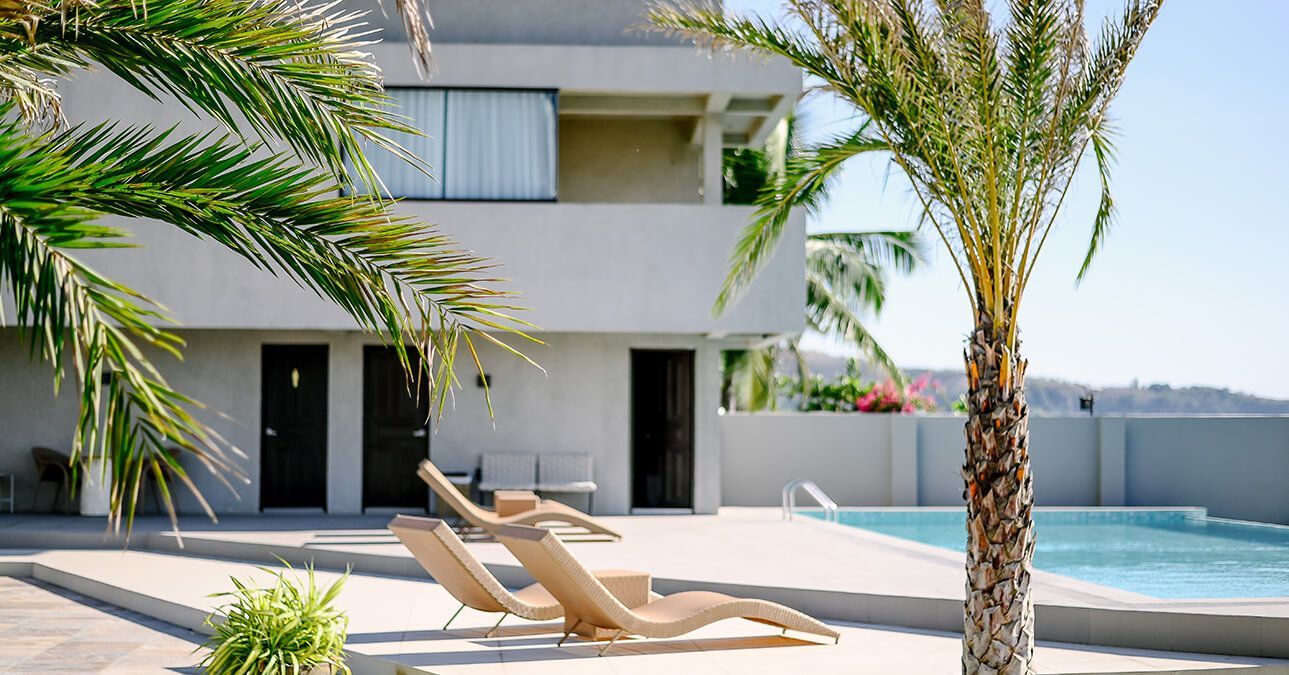 A large house with a swimming pool in front of it