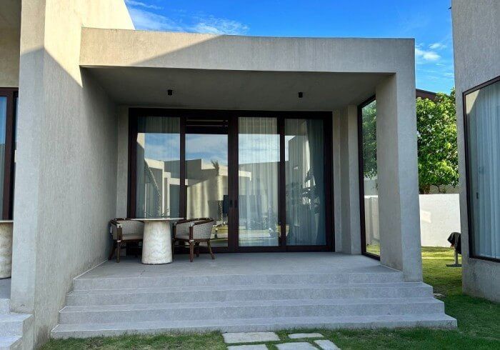 A patio with a table and chairs in front of a house