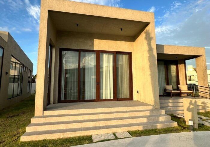 A small house with a lot of windows and stairs