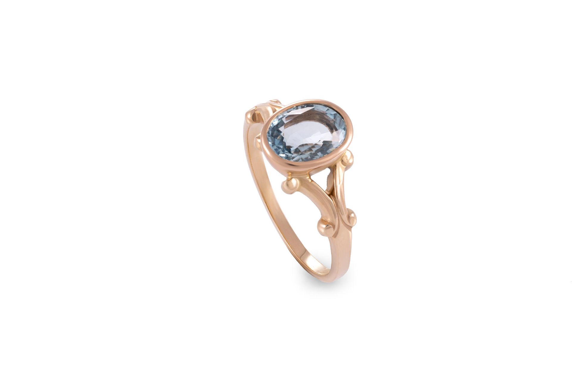 A ring with a blue stone and diamonds on a white background.