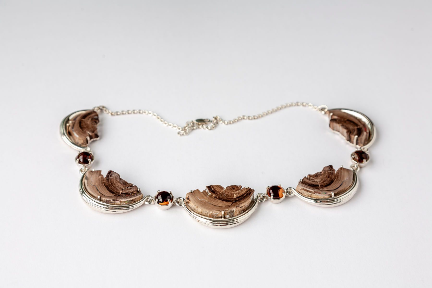 A close up of a necklace on a white surface