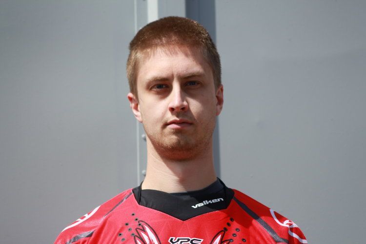 A man wearing a red shirt with the word vfc on it