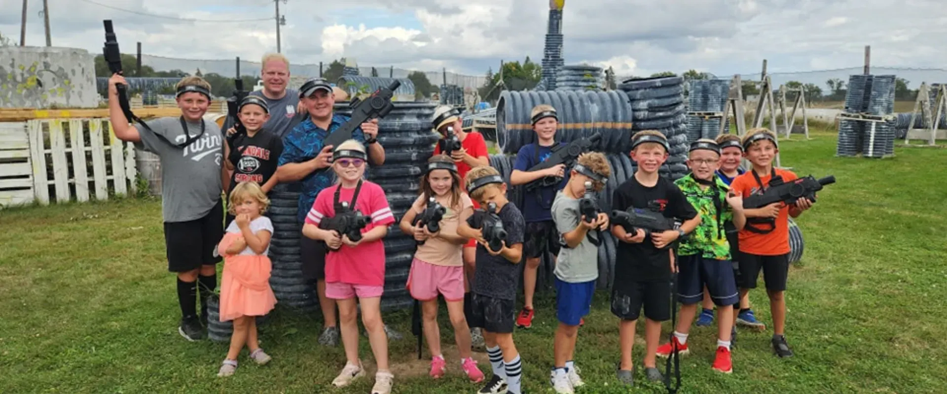 A group of children are posing for a picture while playing laser tag.