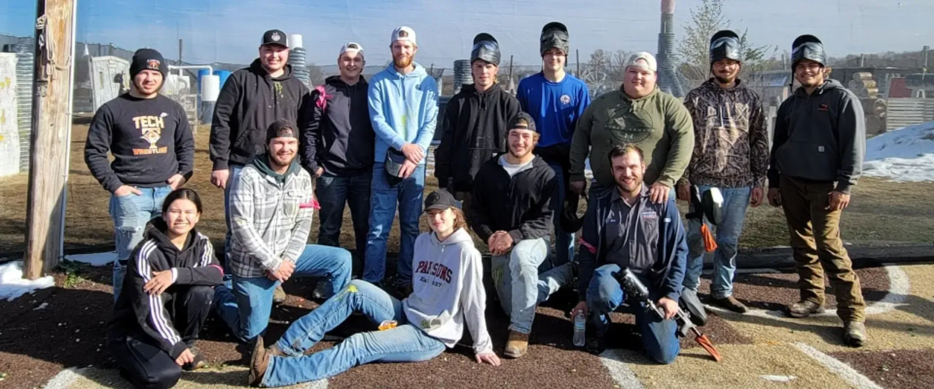 A group of people are posing for a picture in a field.