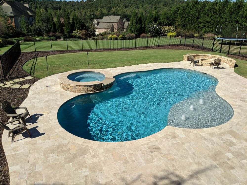 Inground Swimming pool with Blue Wave Pebbletec with Travertine 2