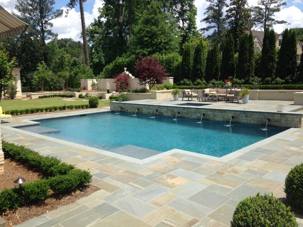 Inground geometric swimming pool with bluestone coping and decking