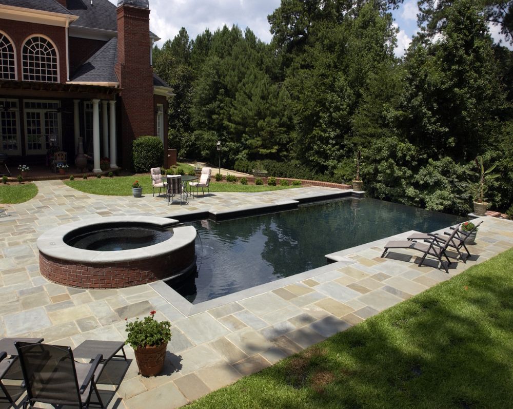 Inground negative edge pool with bluestone deck