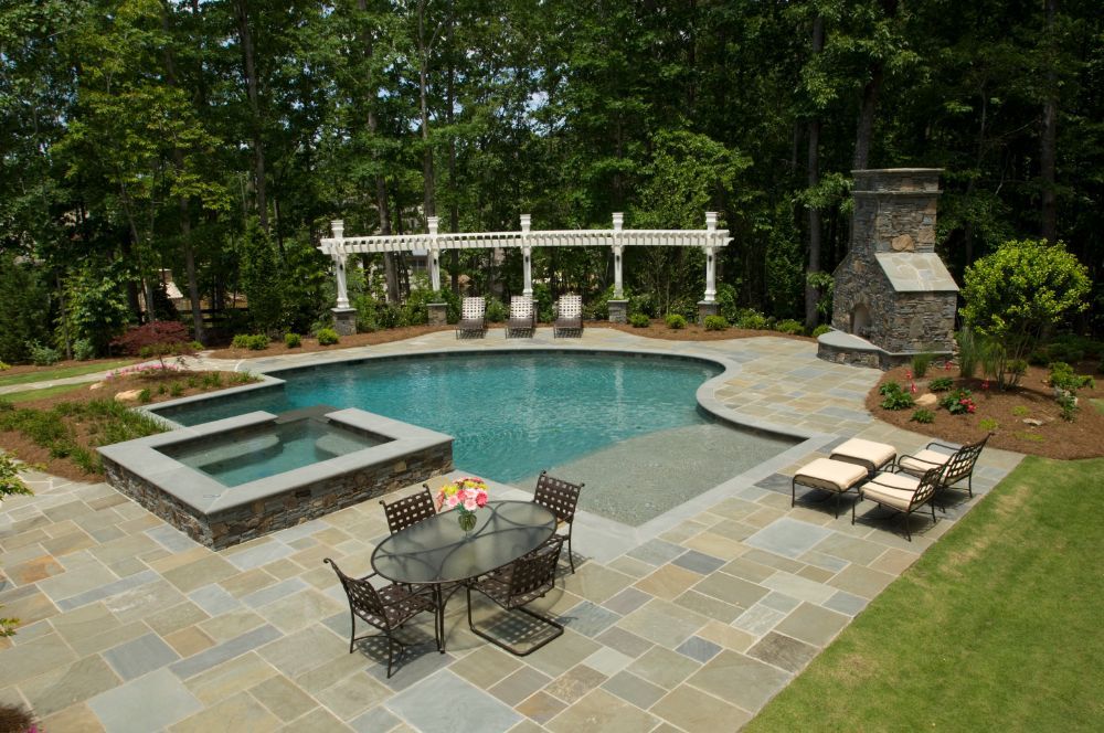 Inground swimming pool and spa with bluestone fireplace